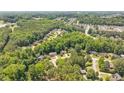 Panoramic aerial view of homes nestled in a lush, green, tree-filled neighborhood with established landscaping at 904 Oldwyck Dr, Fuquay Varina, NC 27526
