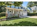 Charming two-story home with a welcoming front porch and well-maintained lawn at 908 Town Side Dr, Apex, NC 27502