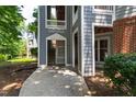 Condo entrance with concrete walkway, gray siding, white trim and unit mailbox at 911 Washington St # 304, Raleigh, NC 27605