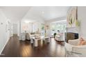 Bright living room featuring dark hardwood floors, white walls, and natural light from large windows at 911 Washington St # 304, Raleigh, NC 27605