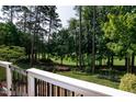 Scenic view of a lush green golf course and trees from a backyard deck at 9136 Palm Bay Cir, Raleigh, NC 27617