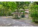 Exterior view of the home nestled among trees, showcasing the natural surroundings at 9507 Sertoma Rd, Chapel Hill, NC 27516