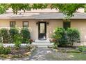 Inviting entrance with a stylish door, complemented by lush landscaping at 9507 Sertoma Rd, Chapel Hill, NC 27516