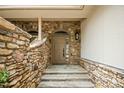 Inviting entryway featuring stone accents, flagstone steps, and a covered porch at 95113 Vance Knls, Chapel Hill, NC 27517