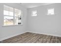 This bedroom has three windows and hardwood floors at 98 Priming Way, Angier, NC 27501