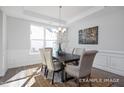 Bright dining room with chandelier, hardwood floors and lots of natural light at 98 Priming Way, Angier, NC 27501