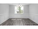 Bright dining room features detailed trim, chandelier lighting, and natural light at 98 Priming Way, Angier, NC 27501
