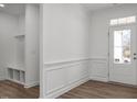 Bright entryway with wainscoting, hall tree and view of the front door at 98 Priming Way, Angier, NC 27501
