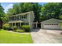 Side view of a two-story home and detached garage, showcasing the home's architecture at 1006 Apache Ln, Apex, NC 27502
