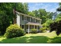 An eye-level view of this beautiful two story home, surrounded by mature trees at 1006 Apache Ln, Apex, NC 27502