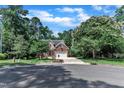 Beautiful home featuring a two-car garage, lawn and surrounding mature trees at 111 Ferncroft Ct, Cary, NC 27519