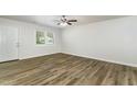 Bright living room featuring wood-look flooring, white walls, and a ceiling fan at 1110 Allgood St, Durham, NC 27704