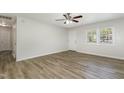 Well-lit living area with wood-look floors, a ceiling fan, and a door to the exterior at 1110 Allgood St, Durham, NC 27704