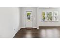 Bright entryway featuring wood flooring, a white door with glass, and a view of the outdoors at 1177 Sun Springs Rd, Wake Forest, NC 27587