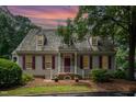 Charming home featuring a cedar shake roof, brick entryway, and well-maintained landscaping at 119 Palace Grn, Cary, NC 27518