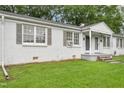 View of the property featuring a green lawn and a well-kept exterior at 1400 Roslyn Dr # 17B, Burlington, NC 27215