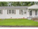 Exterior view of a well-maintained duplex with a green lawn and fresh paint at 1400 Roslyn Dr # 17B, Burlington, NC 27215