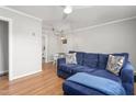 Comfortable living room with hardwood floors and a cozy blue sectional couch with throw pillows at 1400 Roslyn Dr # 17B, Burlington, NC 27215