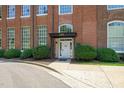 Exterior shot of brick building at 1535, featuring green landscaping and concrete sidewalk at 1535 Caraleigh Mills Ct # 210, Raleigh, NC 27603