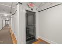 Hallway featuring hardwood floors, black door, and white trim at 1535 Caraleigh Mills Ct # 210, Raleigh, NC 27603