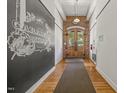 Hallway featuring brick arched doorway, hardwood floors, and historical building art at 1535 Caraleigh Mills Ct # 210, Raleigh, NC 27603
