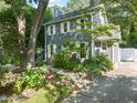 Front exterior with lush garden, showcasing the charming two-story home at 1605 Valley Run, Durham, NC 27707