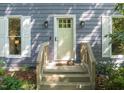 Close-up of the home's front door, showcasing a welcoming entryway with sidelights and a wooden porch at 1605 Valley Run, Durham, NC 27707