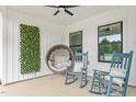 Cozy front porch featuring comfortable seating, decorative plants, and a relaxing atmosphere at 1711 Memory Ln, Burlington, NC 27217