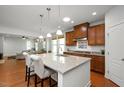 Open-concept kitchen with granite countertops, stainless steel appliances, and a breakfast bar at 1724 Capstone Dr, Durham, NC 27713