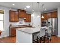 Open-concept kitchen with granite countertops, stainless steel appliances, and a breakfast bar at 1724 Capstone Dr, Durham, NC 27713