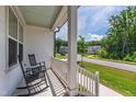 Cozy front porch featuring comfortable rocking chairs and views of the charming neighborhood street at 1928 Vandiver Way, Apex, NC 27523