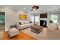 Cozy living room with a fireplace, plush seating, and a ceiling fan at 20 Sugarpine Trl, Clayton, NC 27520
