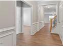 Elegant entryway featuring hardwood floors, wainscoting, and a staircase at 202 Verrazano Pl, Clayton, NC 27520