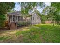 Expansive backyard features a screened porch and deck perfect for outdoor entertaining and relaxation at 2312 Shallowford Ln, Chapel Hill, NC 27517
