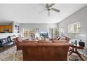 Bright living room with leather furniture, a large window, and a ceiling fan at 2910 Barrymore St # 100, Raleigh, NC 27603