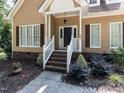 Inviting front porch with white railings and brick steps leading to the entrance at 301 Monterey Ct, Benson, NC 27504