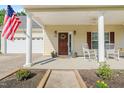 Inviting front porch with white rocking chairs, planters, ceiling fan and tasteful decor at 303 Sylvias Ct, Durham, NC 27703