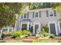 Charming townhomes featuring beautiful landscaping, front steps and gray siding at 318 Silverberry Ct, Cary, NC 27513