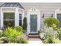 Close up of the front door showing beautiful landscaping, brick, and gray siding at 318 Silverberry Ct, Cary, NC 27513
