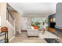 Bright living room with a large bay window, neutral colors, and modern fireplace at 318 Silverberry Ct, Cary, NC 27513