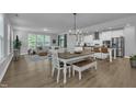 Inviting dining area with hardwood floors, seamlessly connected to a spacious living room and kitchen at 325 Buckhorn Branch Park, Clayton, NC 27520