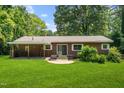 Expansive backyard featuring a covered patio and lush green grass, perfect for outdoor gatherings at 330 Wilmot Dr, Raleigh, NC 27606