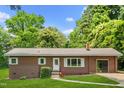 Charming ranch home with a well-maintained lawn and a cozy, inviting entrance at 330 Wilmot Dr, Raleigh, NC 27606