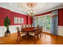 Formal dining room boasts an elegant chandelier, wainscoting, and decorative ceiling at 3728 Westbury Lake Dr, Raleigh, NC 27603