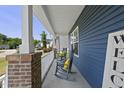 Relaxing front porch with rocking chairs, perfect for enjoying peaceful outdoor moments at 374 Heart Pine Dr, Wendell, NC 27591