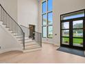 Bright foyer with soaring ceilings, a grand staircase, and an abundance of natural light at 4 Rainforest Pl, Apex, NC 27523