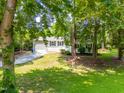 The exterior is beautifully framed by mature trees, offering shade and enhancing the home's curb appeal at 4001 Pin Oak Rd, Raleigh, NC 27604