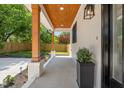 Wide covered porch with wood columns, tongue and groove ceiling, and views of the landscaped front yard at 411 Bon Air Ave, Durham, NC 27704