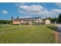 Fenced yard featuring a well-maintained lawn and a storage shed at 4536 Massey Rd, Zebulon, NC 27597