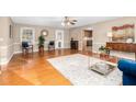 Bright living room featuring hardwood floors, stylish furnishings, and a view to the kitchen at 4536 Massey Rd, Zebulon, NC 27597